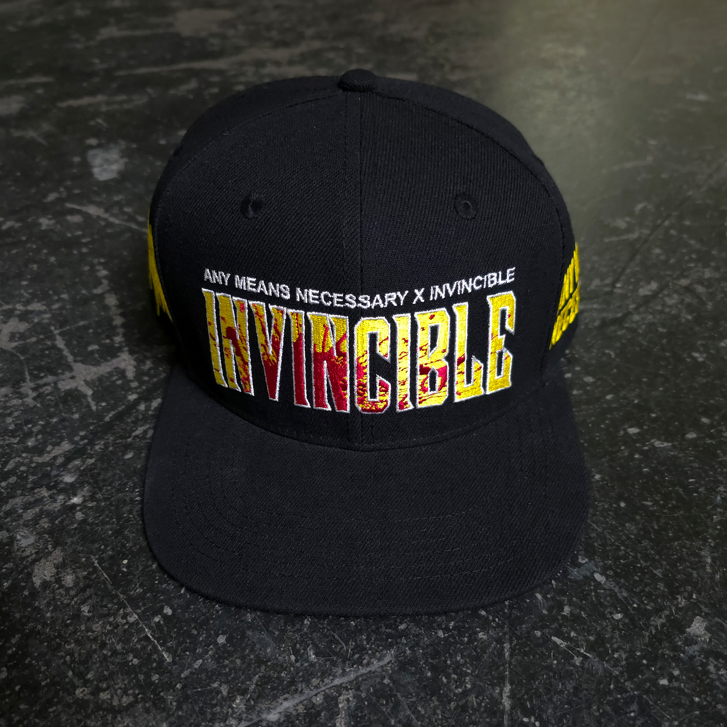 Invincible Splatter Hat – Any Means Necessary Clothing