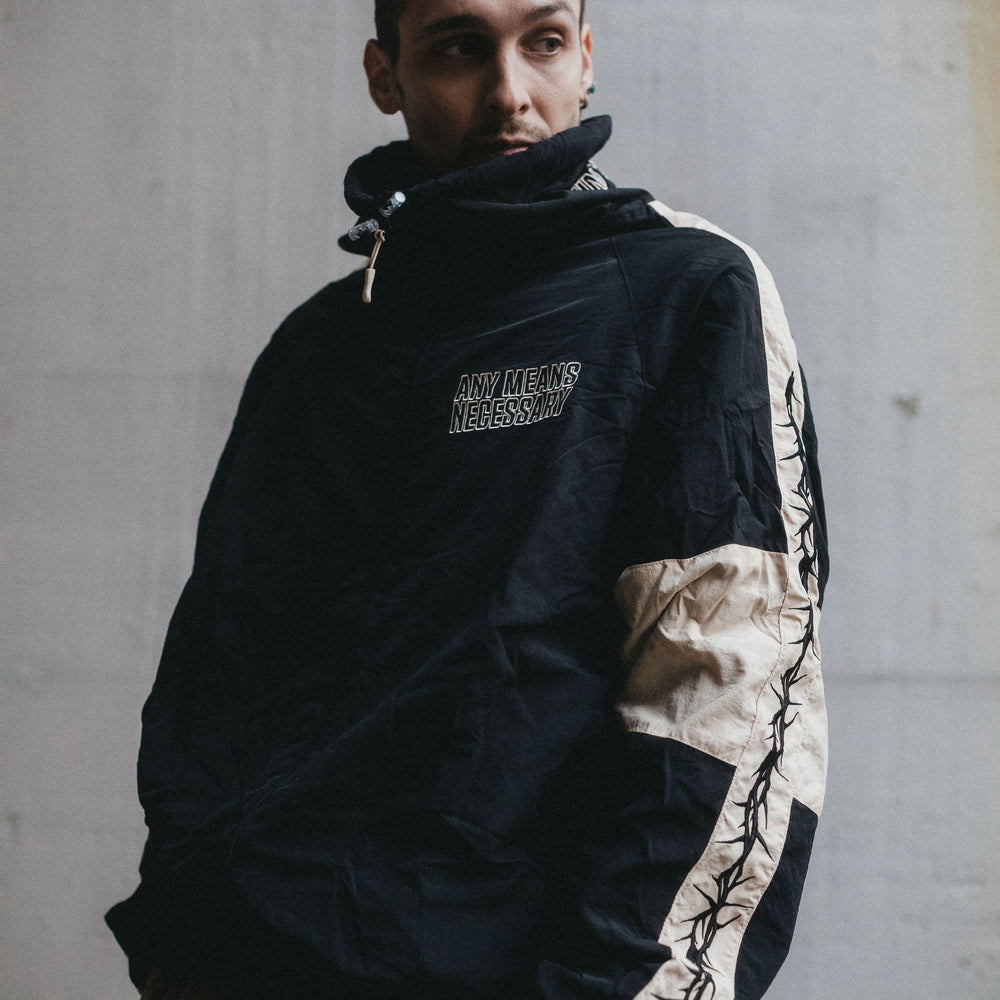 
                      
                        any means necessary shawn coss dust storm windbreaker black and tan lifestyle front
                      
                    