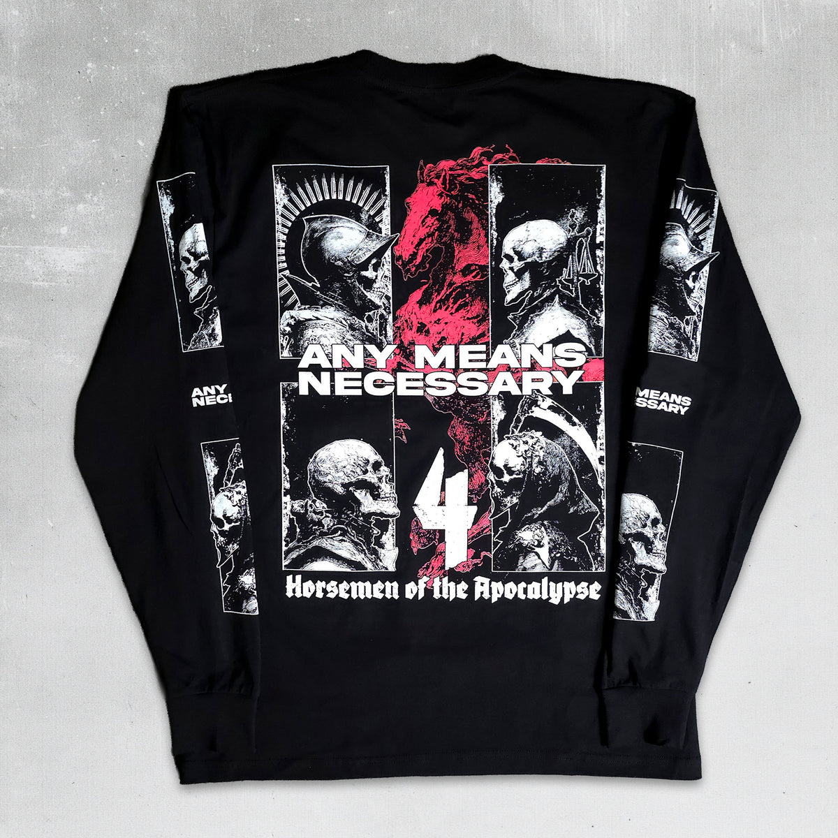 A black long-sleeve graphic shirt laid flat on a light gray textured background. The back features a large white and red print with skulls, the text 'ANY MEANS NECESSARY', a large white '4', and 'Horsemen of the Apocalypse' at the bottom.