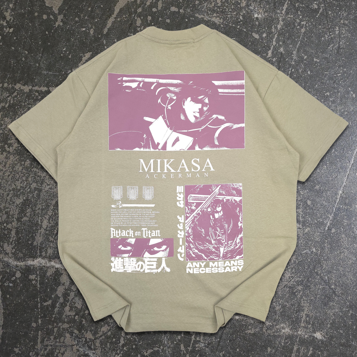 A light green short-sleeve t-shirt laid flat on a dark textured surface, featuring a large purple and white graphic print on the back with the text 'MIKASA ACKERMAN' and various anime-themed panels. Attack on Titan Any Means Necessary