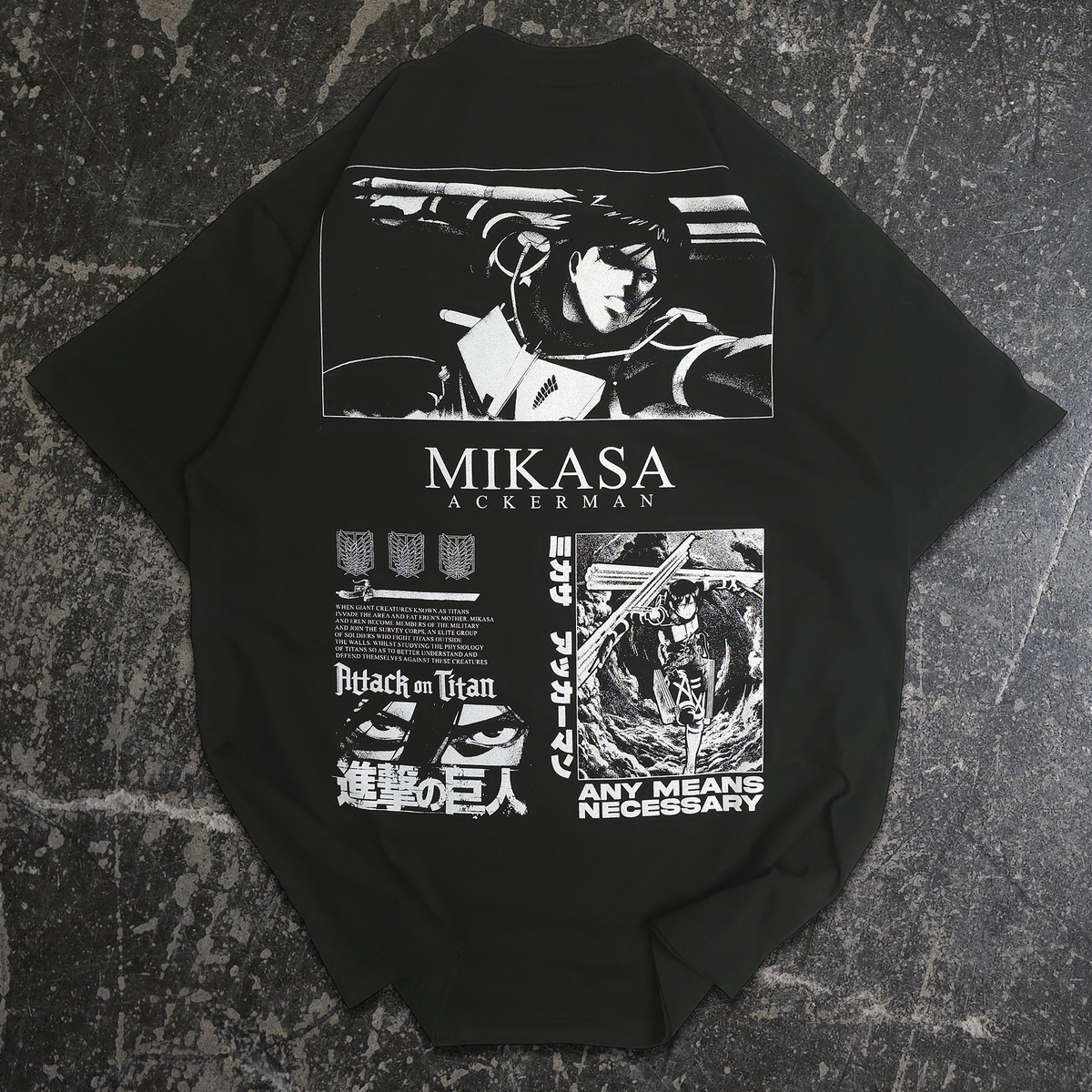 A black short-sleeve T-shirt laid flat on a dark textured surface, featuring large white graphic prints from Attack on Titan, including a Mikasa Auerman illustration and the text 'MIKASA AKERMAN' and 'ANY MEANS NECESSARY'.