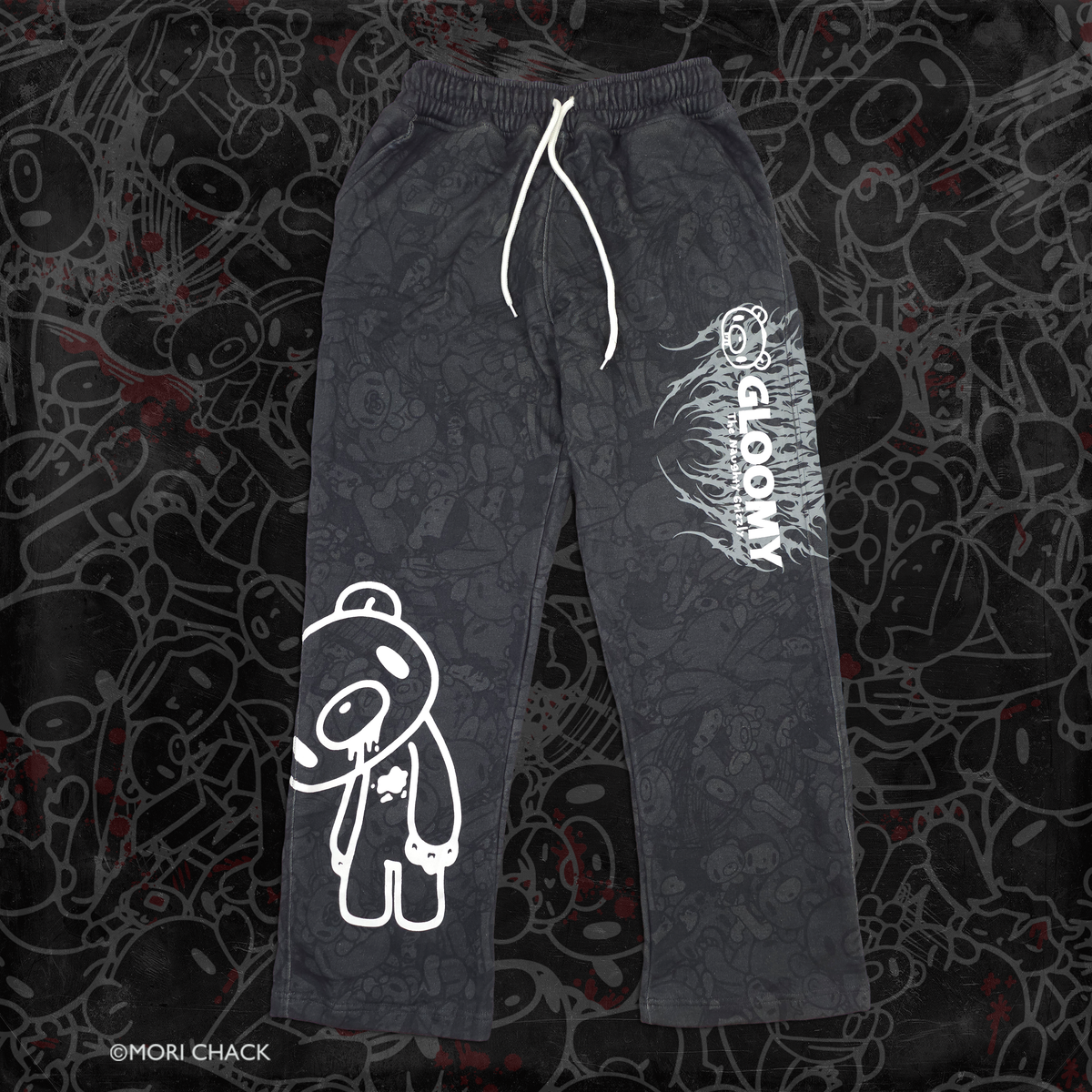 Black shorts featuring a white outline cartoon bear graphic on the left leg and vertical white 'GLOOMY' branding with smaller text on the right leg, shown against a dark textured background.