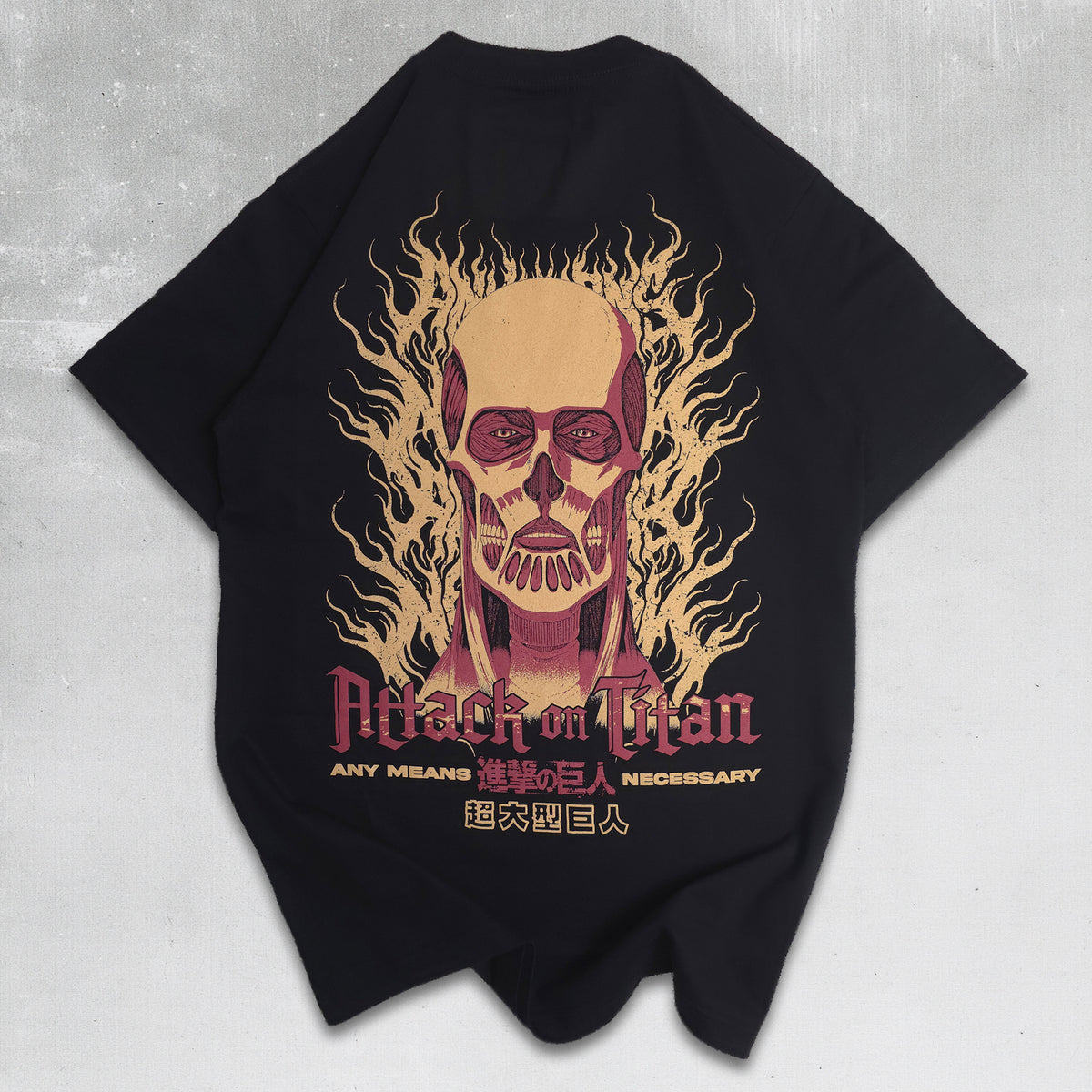 A black short-sleeve graphic t-shirt featuring the Attack on Titan character Titan Smith with a flaming skull design and text on the front, laid flat on a textured gray background.