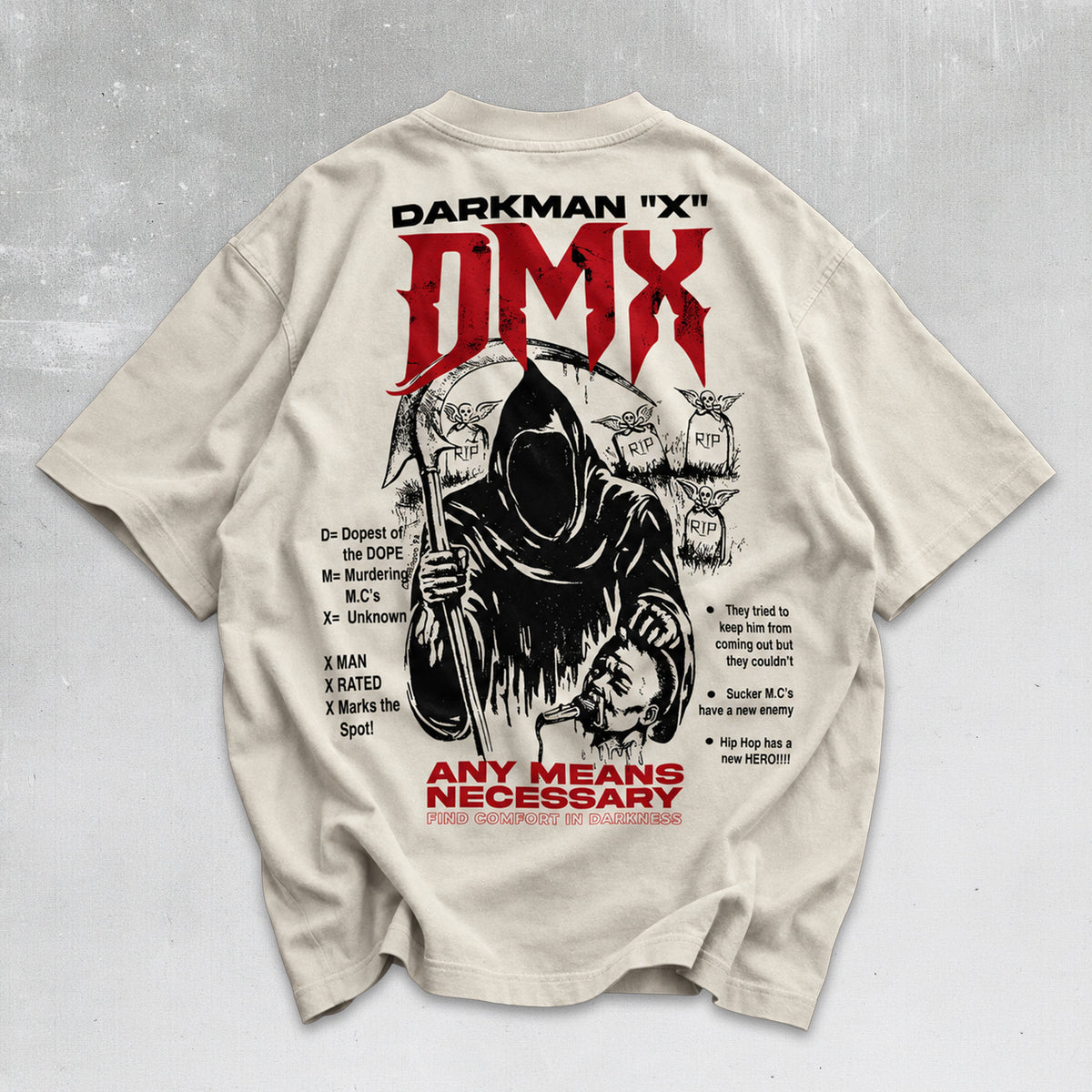A beige graphic t-shirt laid flat on a textured gray background, showing the back print with 'DMX' in red and black, a grim reaper illustration, and additional text.