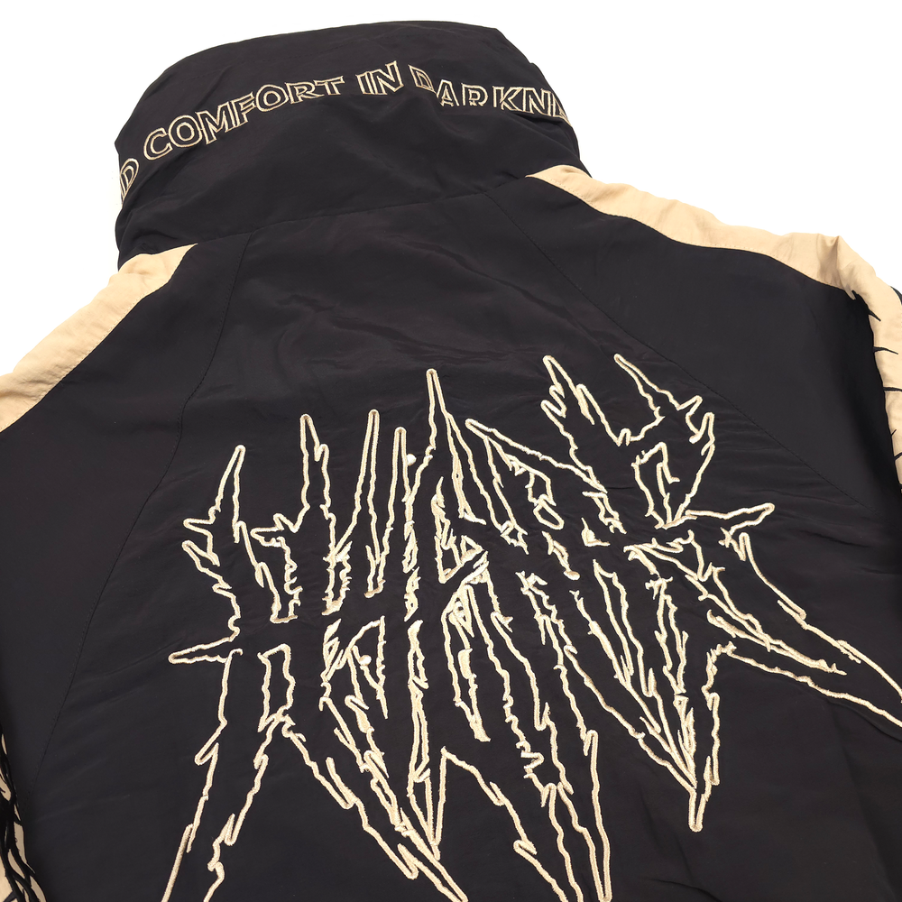 
                      
                        any means necessary shawn coss dust storm windbreaker black and tan back up close
                      
                    
