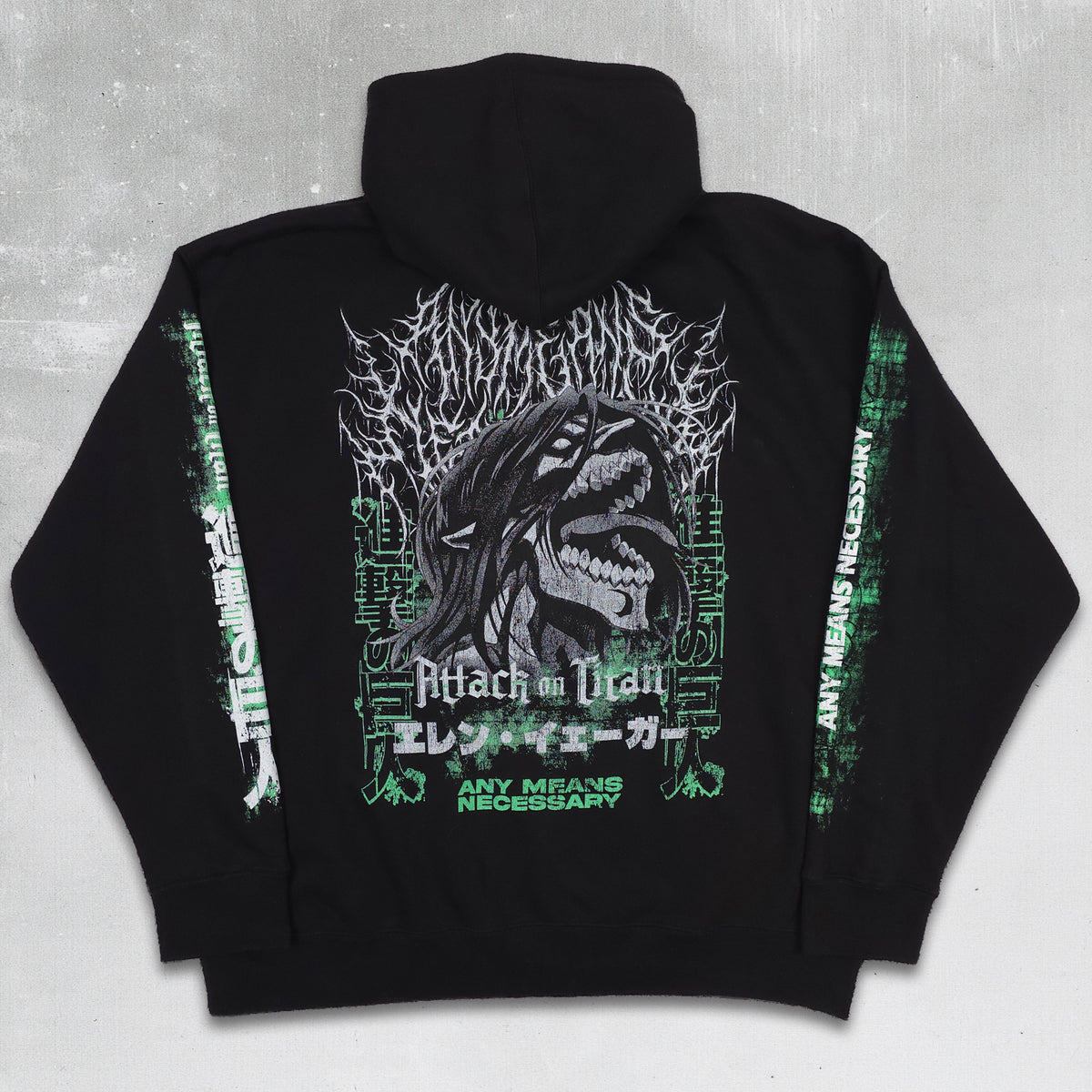 Black pullover hoodie shown from the back, featuring a large graphic print of a shark head with the text 'Attack on Titan' and 'Any Means Necessary' in white and green, displayed on a textured gray background.