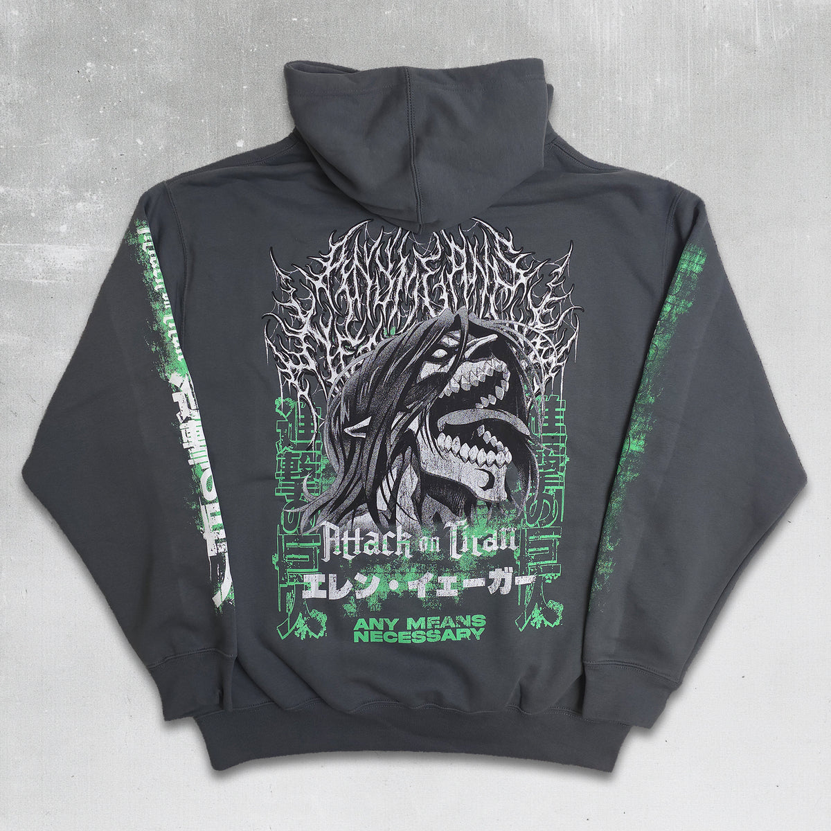 A dark gray hoodie shown from the back, featuring a large graphic print of a screaming shark with the text 'Attack on Titan' and Japanese characters, accented with green details on the sleeves and sides.