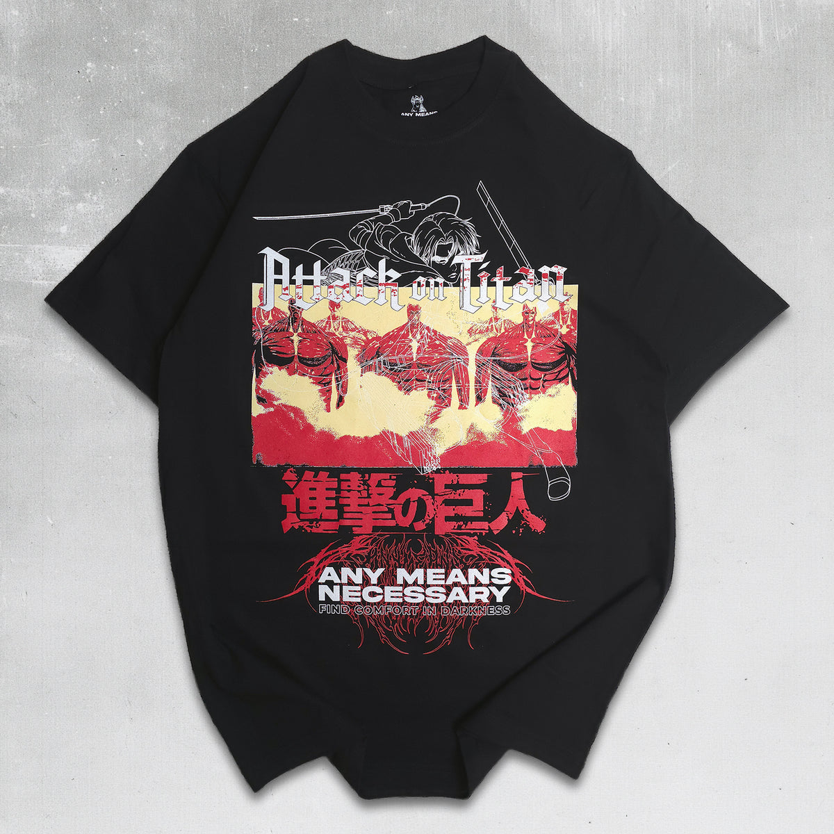 A black short-sleeve graphic t-shirt featuring the Attack on Titan design with red, yellow, and white elements, laid flat on a textured gray background.