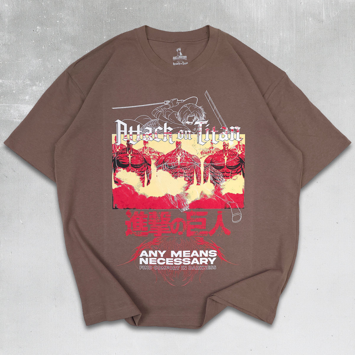 A brown short-sleeve graphic t-shirt featuring Attack on Titan artwork with red and yellow elements and the text 'ANY MEANS NECESSARY', laid flat on a textured gray background. Levi Ackerman