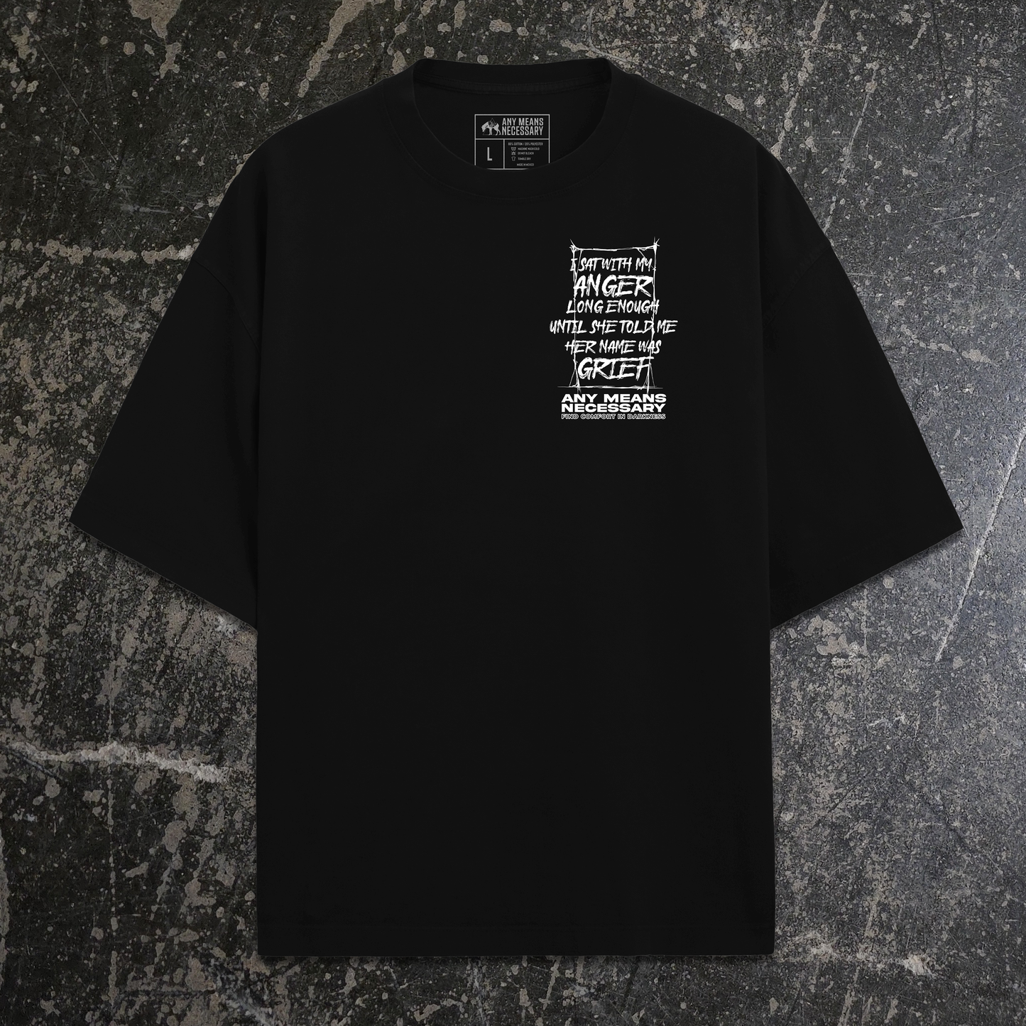 Black shirt with a white graphic design on the back against a textured gray background, shawn coss art about grief