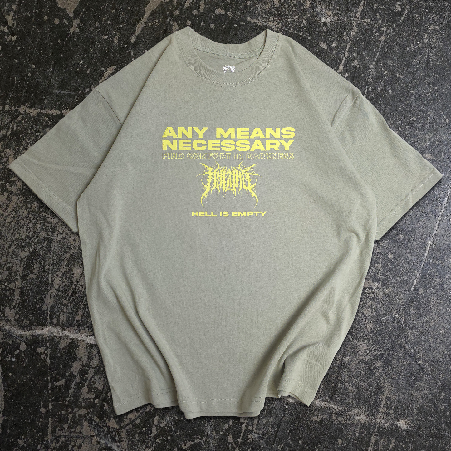 Green t-shirt with yellow text and graphic on a textured black surface