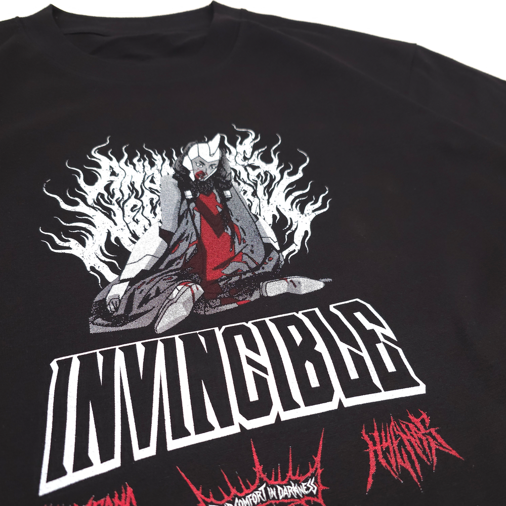 
                      
                        Black t-shirt with a graphic design of a character in a meditative pose with flames, the word 'INVINCIBLE', and red text on a white background.
                      
                    