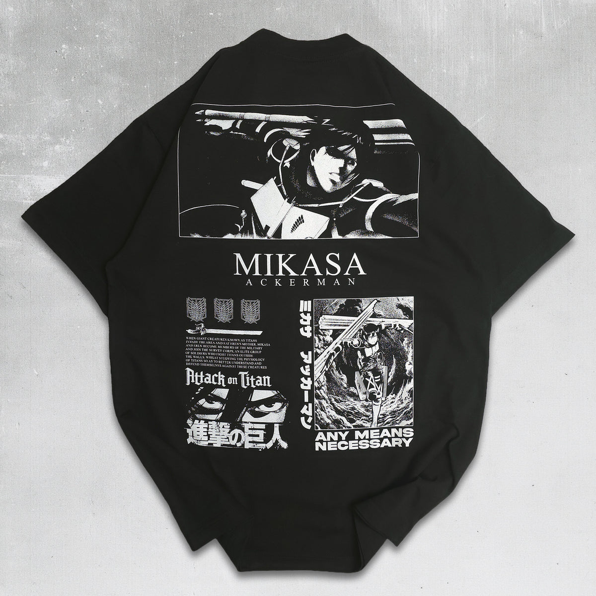 A black short-sleeve T-shirt laid flat on a dark textured surface, featuring large white graphic prints from Attack on Titan, including a Mikasa Auerman illustration and the text 'MIKASA AUERMAN' and 'ANY MEANS NECESSARY'.