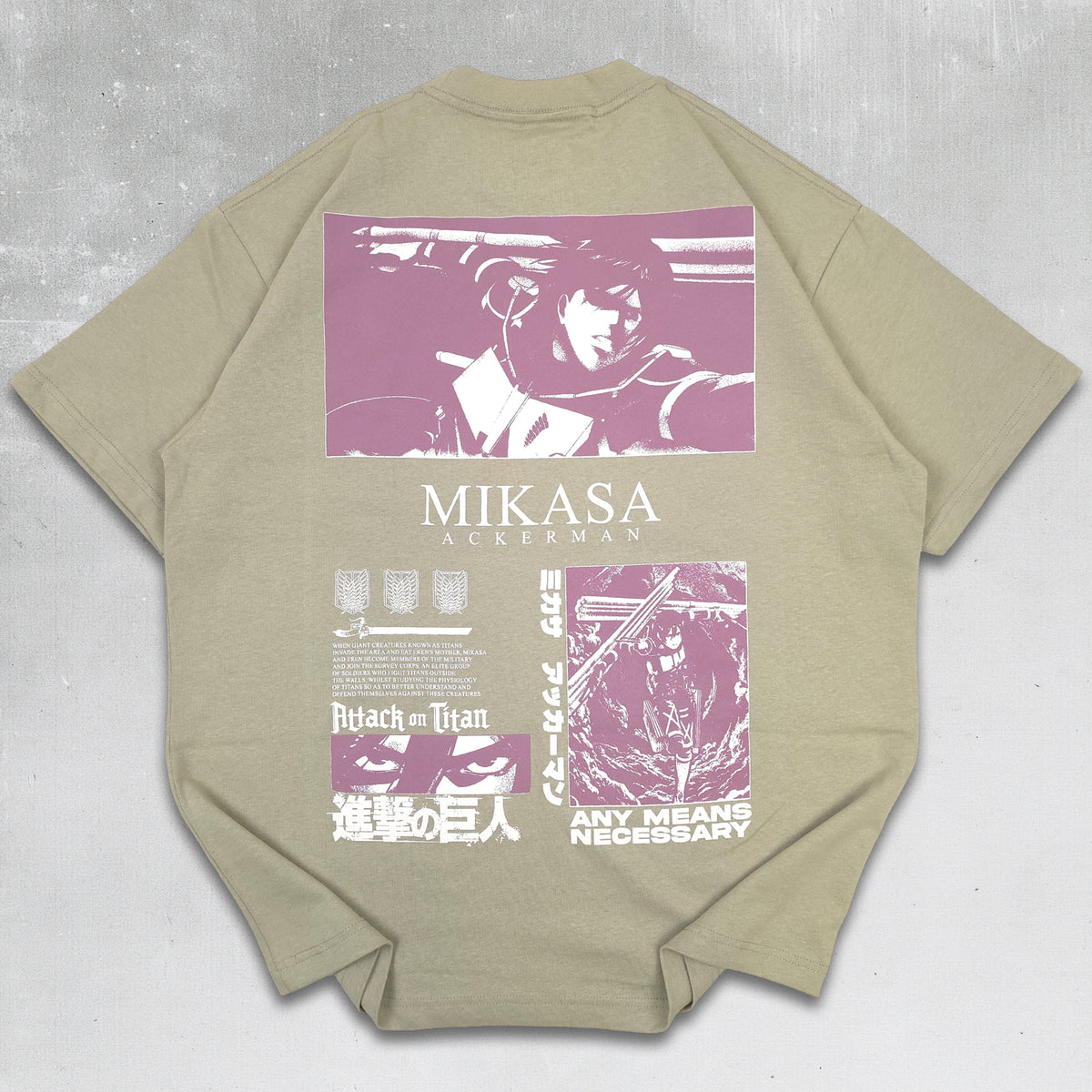 A light olive green short-sleeve t-shirt laid flat on a dark textured background, showcasing a large graphic print on the back. The print features a purple and white illustration from Attack on Titan with the text 'MIKASA AOKATA' and 'ANY MEANS NECESSARY'.