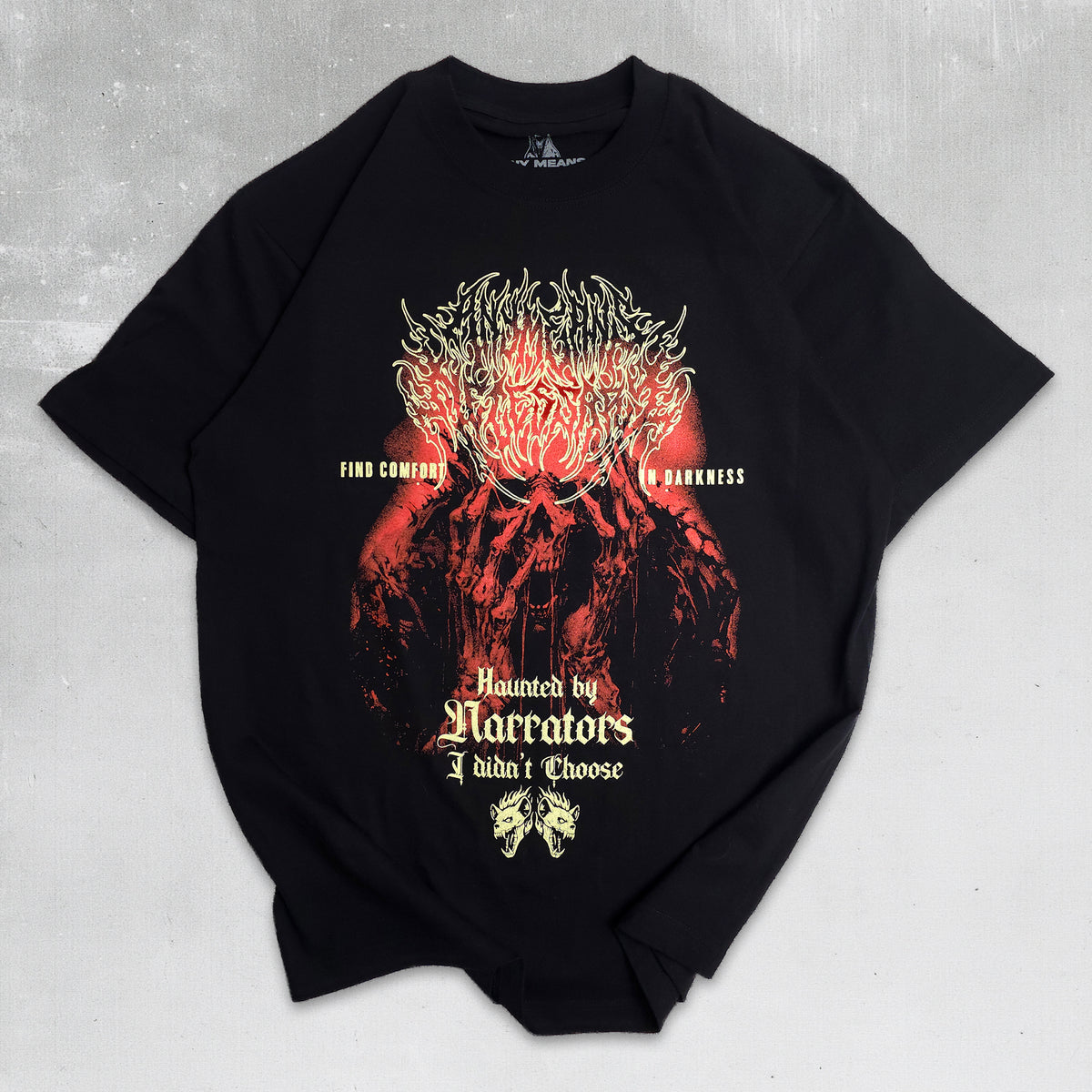 A black short-sleeve graphic t-shirt laid flat on a textured gray background. The shirt features a large, detailed red and black graphic of a skull-like figure with glowing red eyes and sharp teeth, accompanied by gothic-style text that reads 'Haunted by Narrators I didn't Choose' and 'Find Courage in Darkness'.