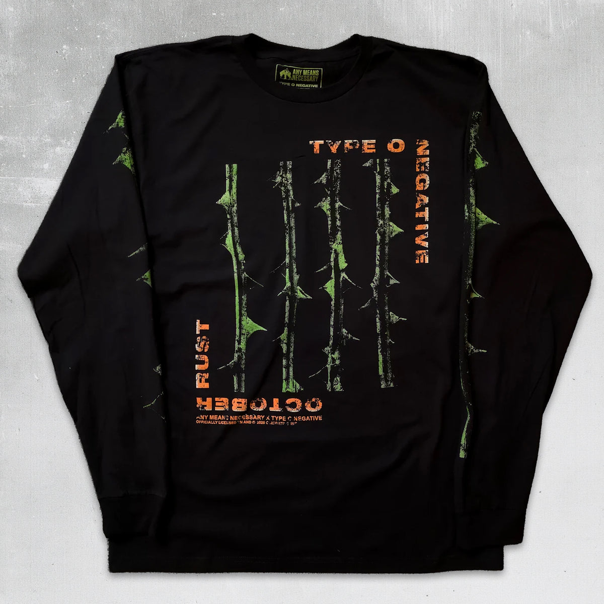 A black long-sleeve crewneck sweatshirt featuring a graphic print of green bamboo stalks and orange text on the front, laid flat on a textured gray background. Type o negative october rust long sleeve