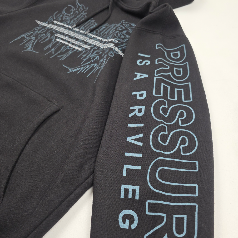 
                      
                        any means necessary shawn coss pressure is a privilege pullover hoodie black up close sleeve
                      
                    