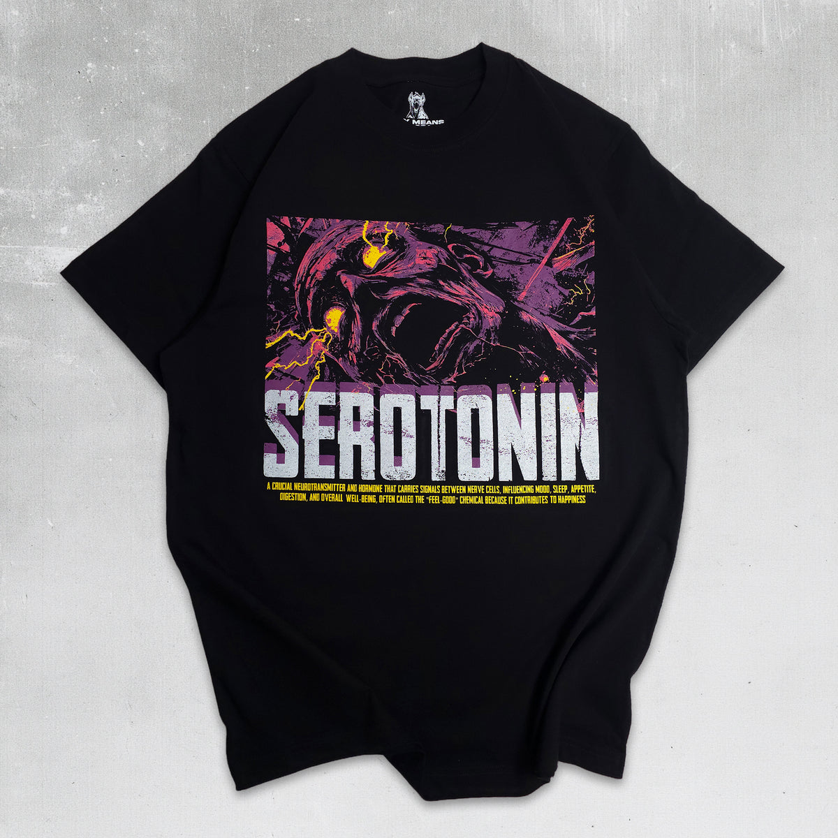 A black short-sleeve t-shirt with a large graphic print on the front featuring a purple and black illustrated character with yellow highlights, the word 'SEROTONIN' in bold white letters, and smaller yellow text below, laid flat on a gray textured background.