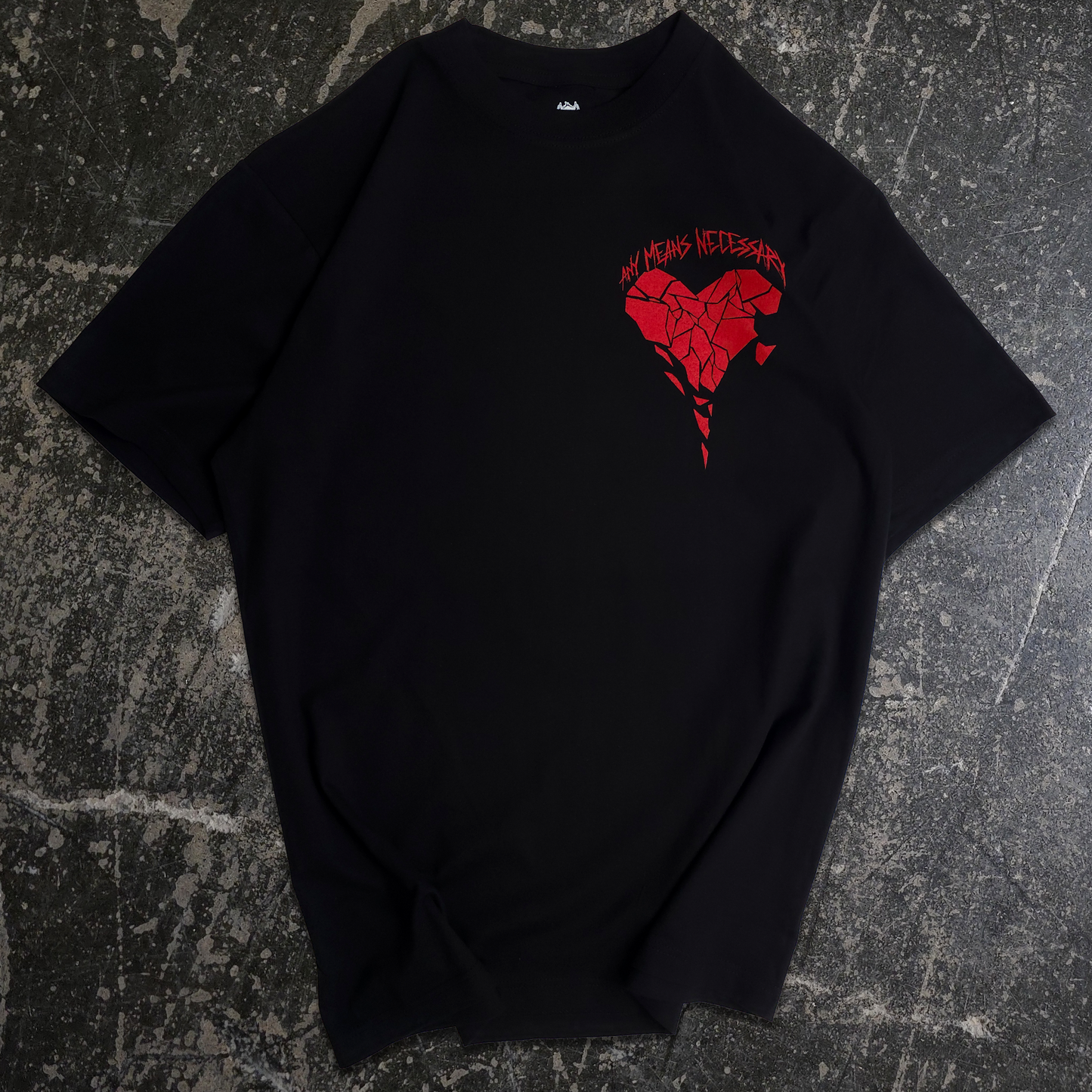Black t-shirt with a red heart design on a textured gray background