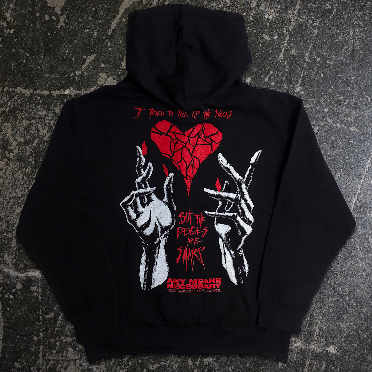 Black zip up with red and white graphic design on a white background
any means necessary shawn coss sharp edges t shirt black broken heart with hand drawn hands