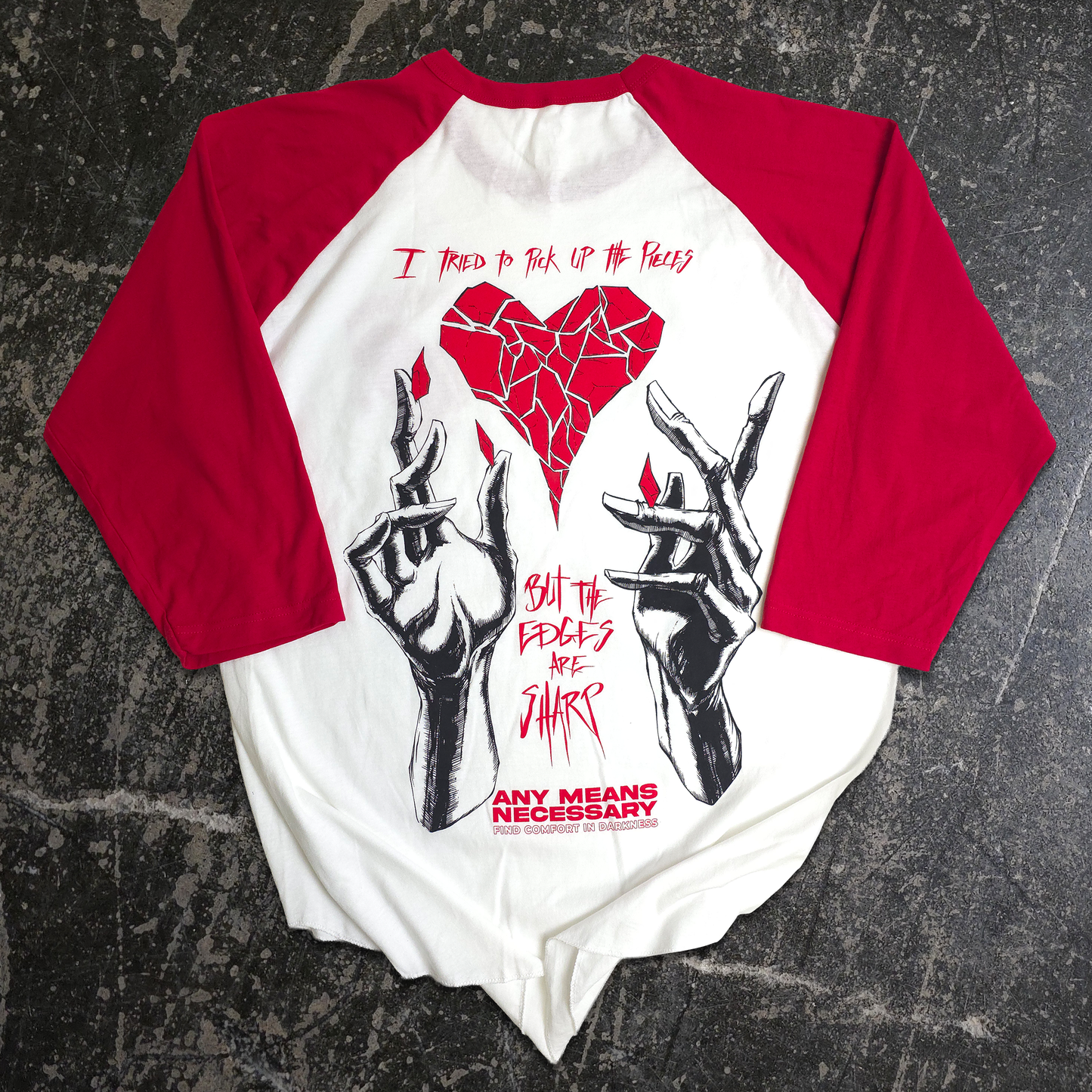 Baseball shirt with graphic design and text on a textured surface
Sharp Edges by Shawn Coss, broken heart and creepy hands