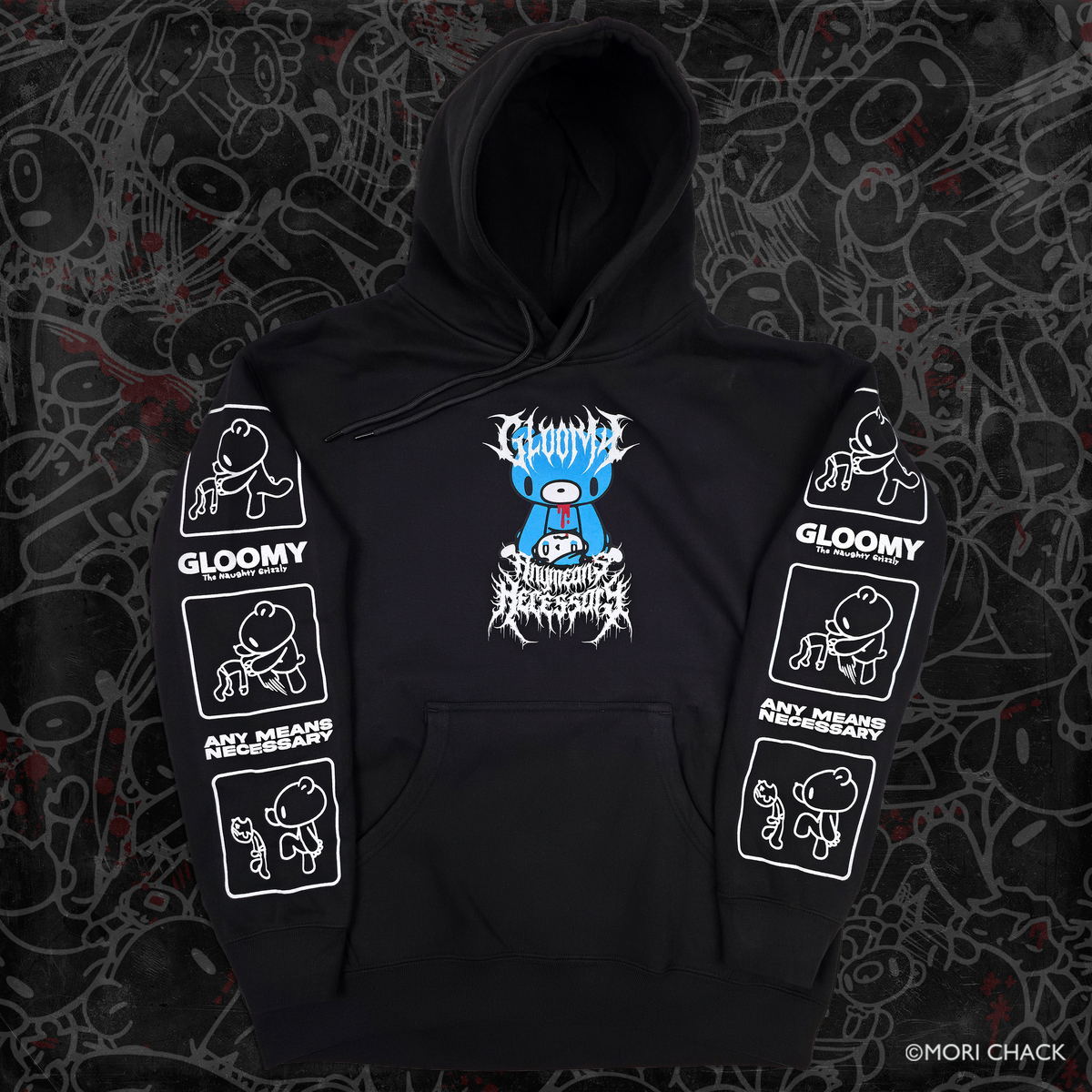 A black pullover hoodie laid flat on a dark patterned background. The hoodie features a blue cartoon bear graphic with white text on the chest, and white graphic panels printed on both sleeves.