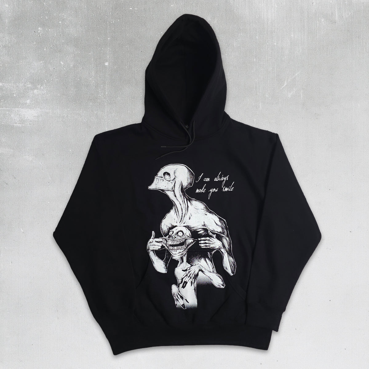 A black pullover hoodie with a detailed white graphic print of a skeletal creature holding a skull, accompanied by the handwritten text 'I can always kill you back'. The hoodie is laid flat against a textured gray background.