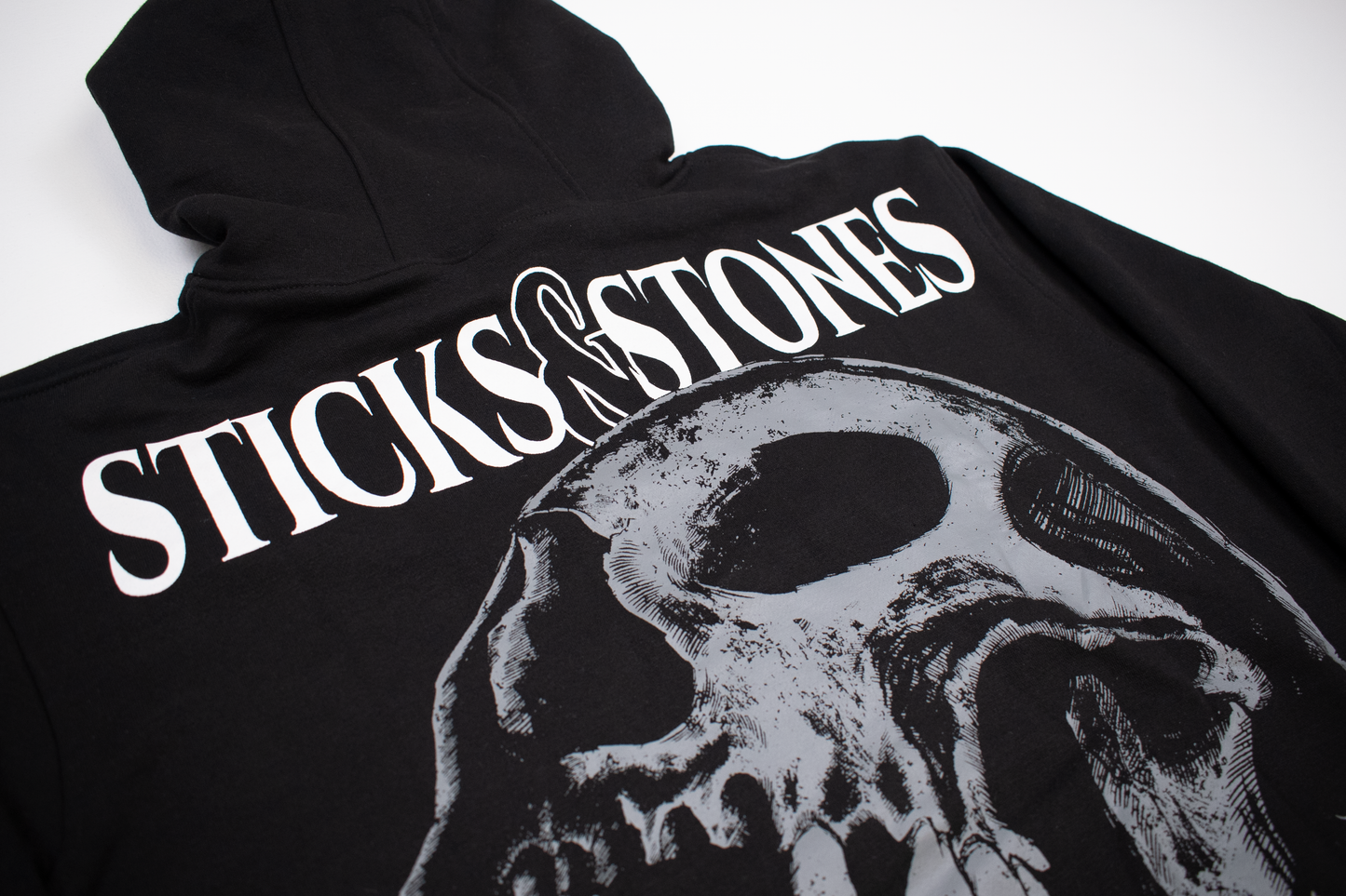 
                  
                    any means necessary shawn coss sticks and stones pullover hoodie black back up close
                  
                