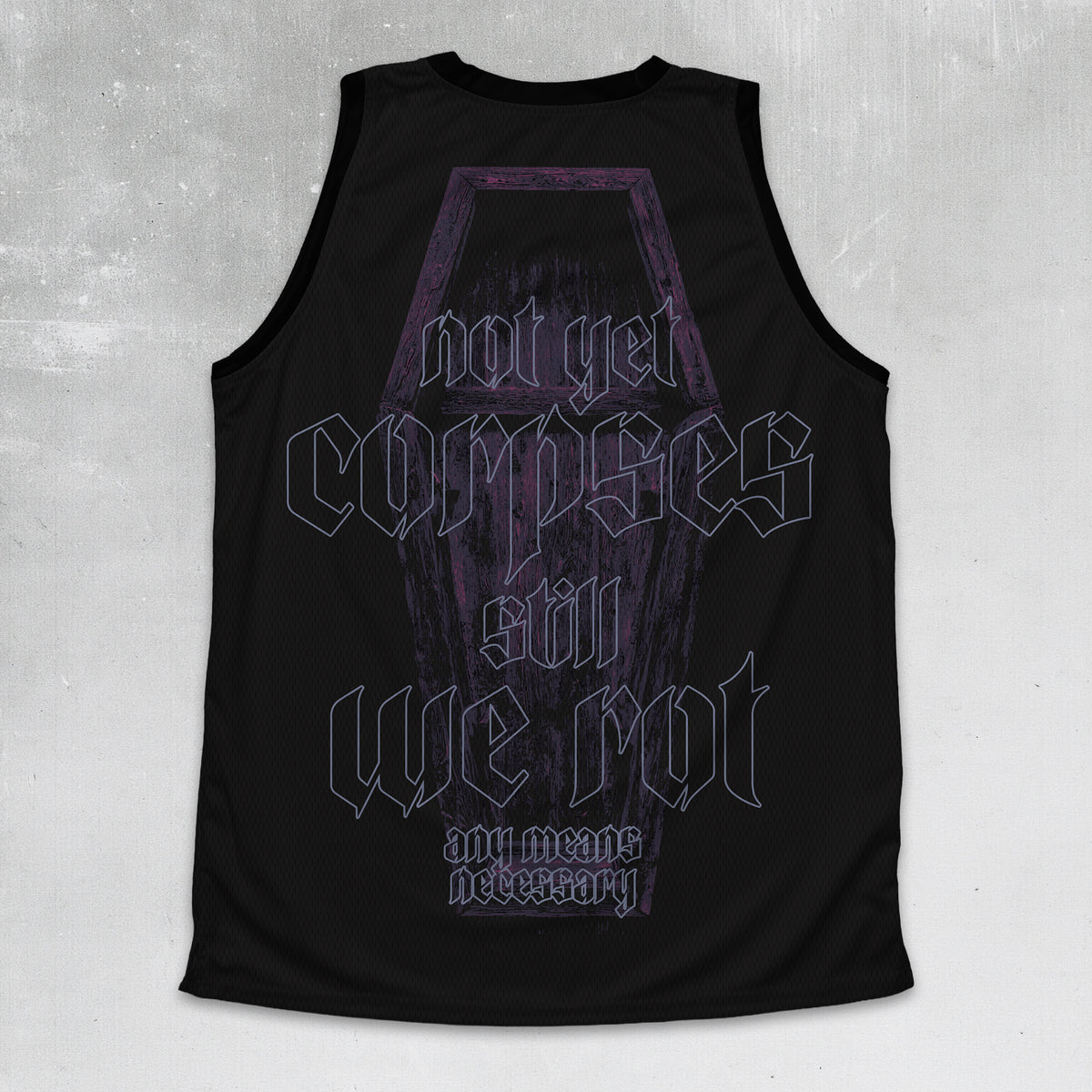 A black sleeveless tank top with a gothic-style graphic on the front featuring a coffin illustration and the text 'not yet corpses will we not and means necessary' in stylized lettering, shown against a textured gray background.