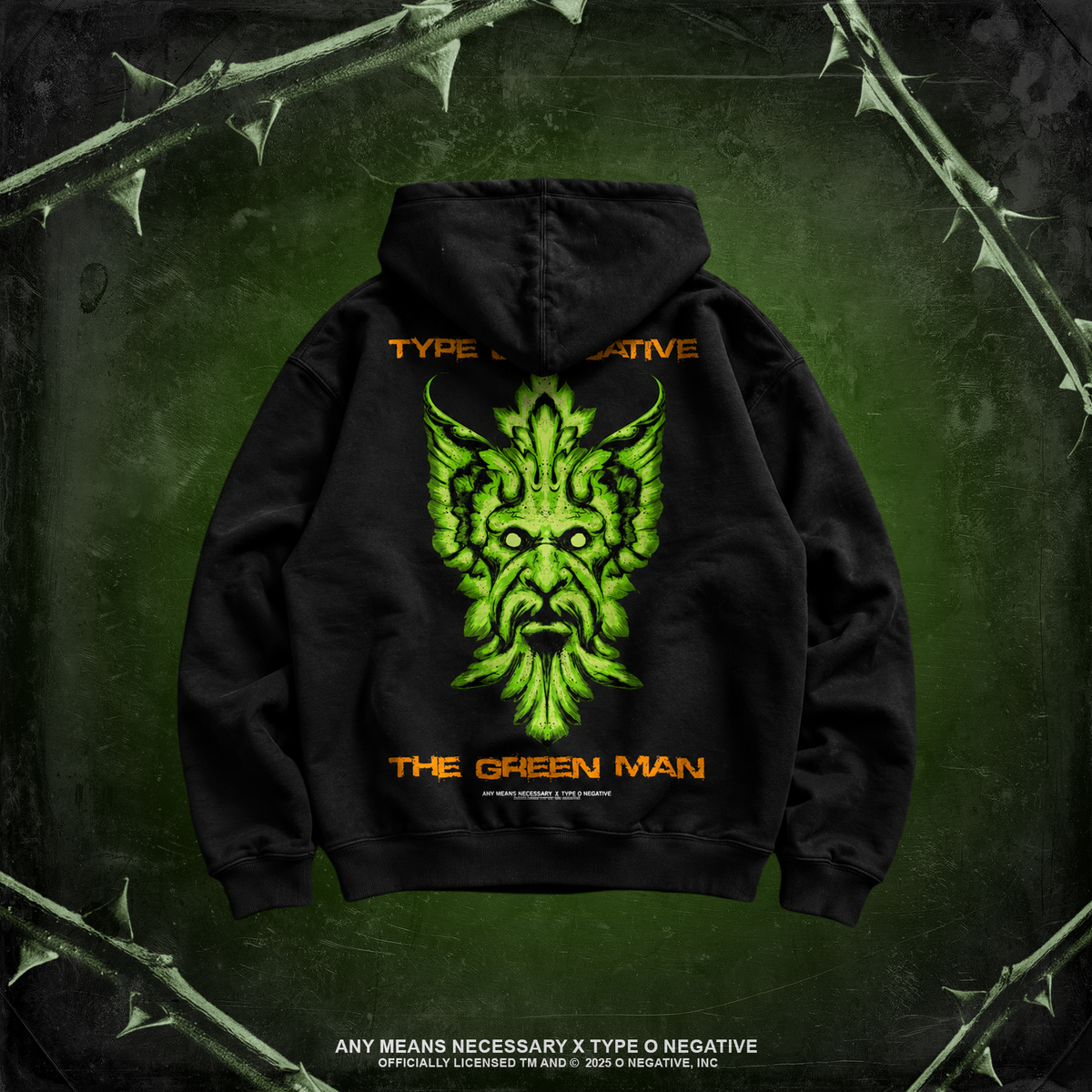 A black pullover hoodie shown from the back, featuring a large neon green monster face graphic with the words 'TYPE NEGATIVE' above and 'THE GREEN MAN' below in orange. The hoodie is centered on a dark green textured background with thorny branches around the edges.