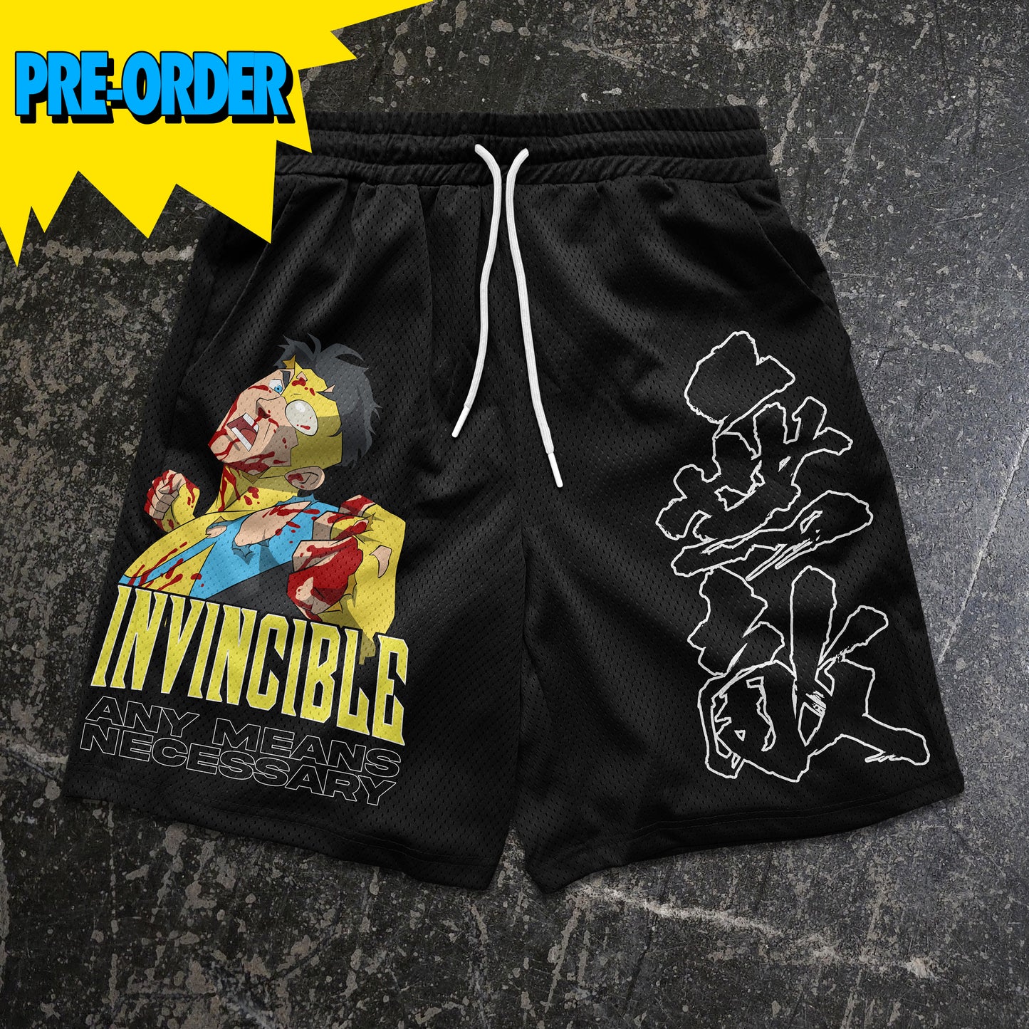 Black shorts with graphic designs and text on a textured gray background