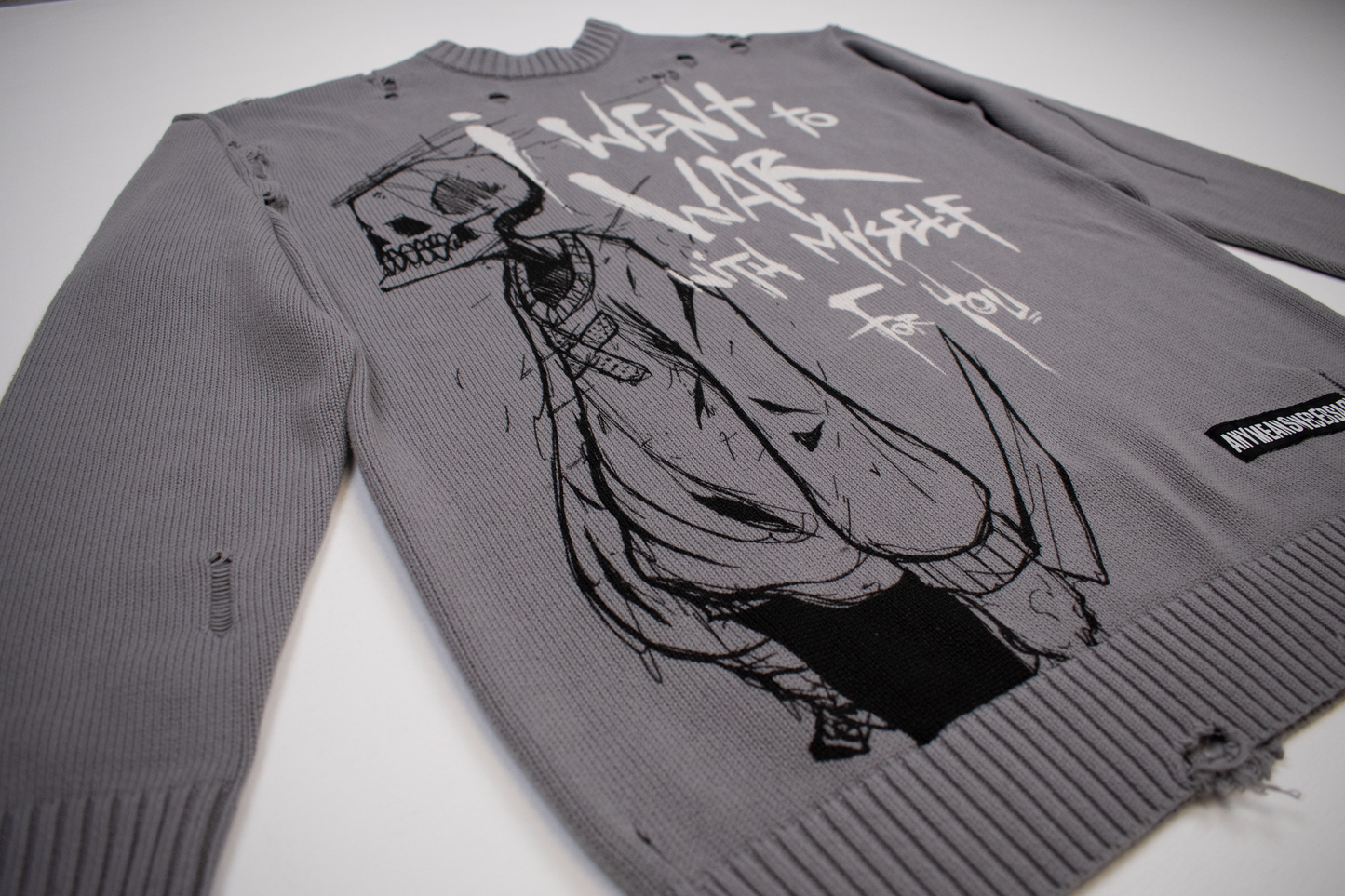 
                  
                    any means necessary shawn coss war with myself knit sweater front side 
                  
                