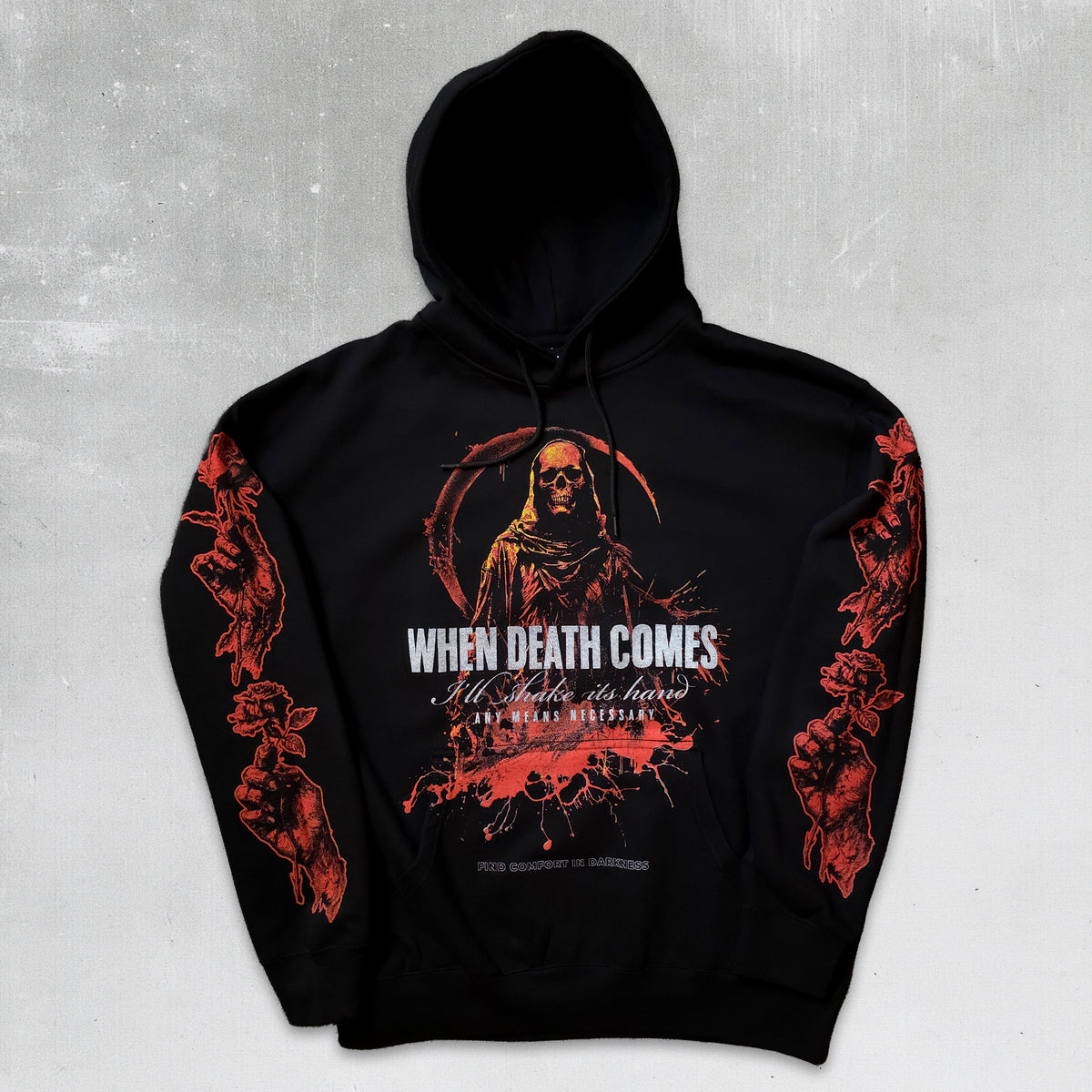 A black pullover hoodie with a detailed red and white graphic print on the front and sleeves, featuring the text 'WHEN DEATH COMES' and 'All Souls are here IN MY MEMORY', displayed against a textured gray background.